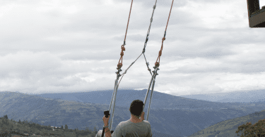 Swing at the end of the world in Banos, Ecuador
