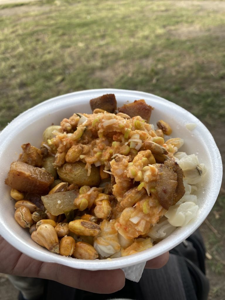 trying Motte con chicharron on street market in Quito