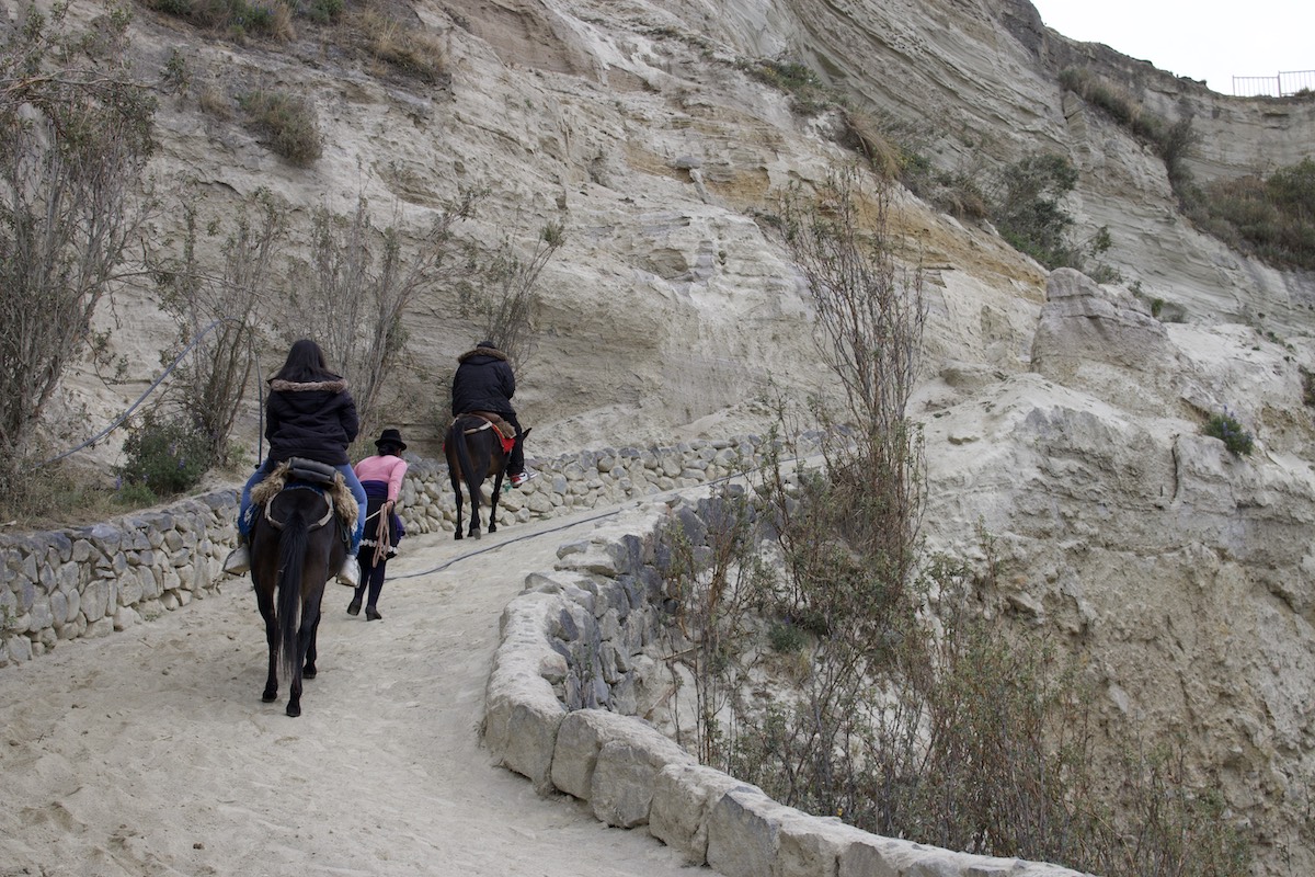 People using mules to go all the way up to the top of the Quilotoa Lake, Ecuador