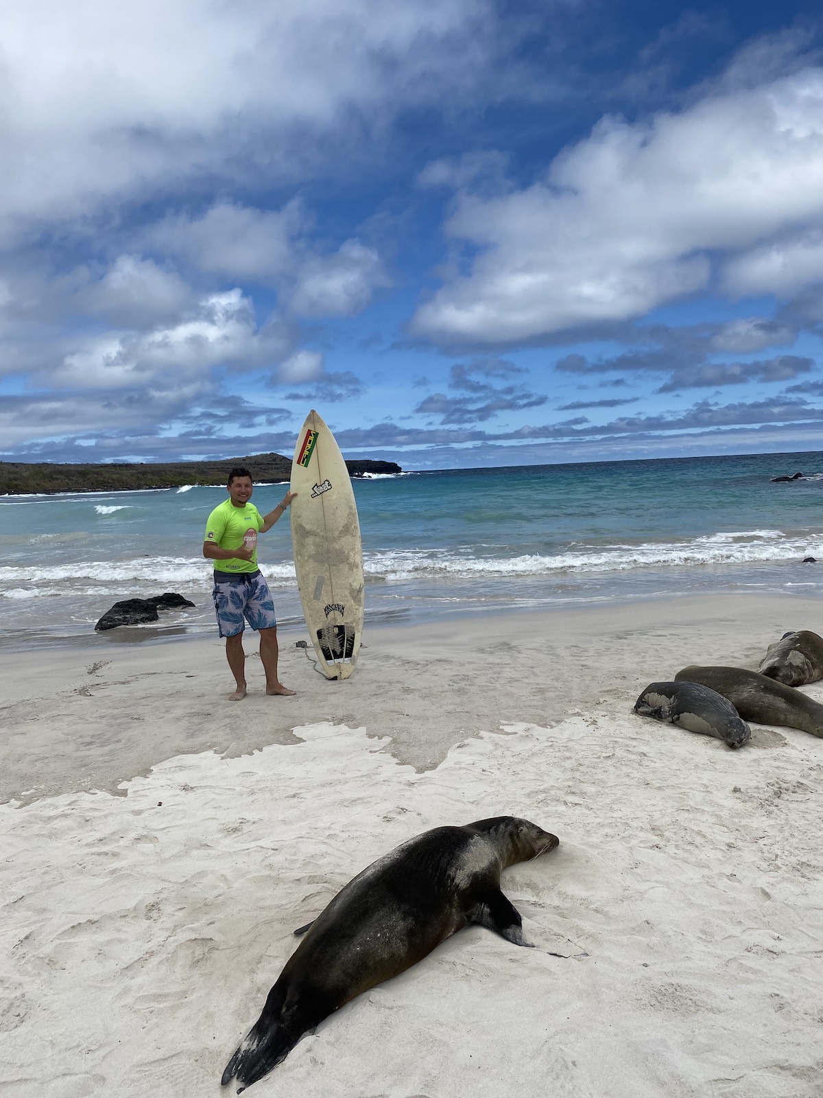 Surfing on Puerto Chino beach on Galapagos