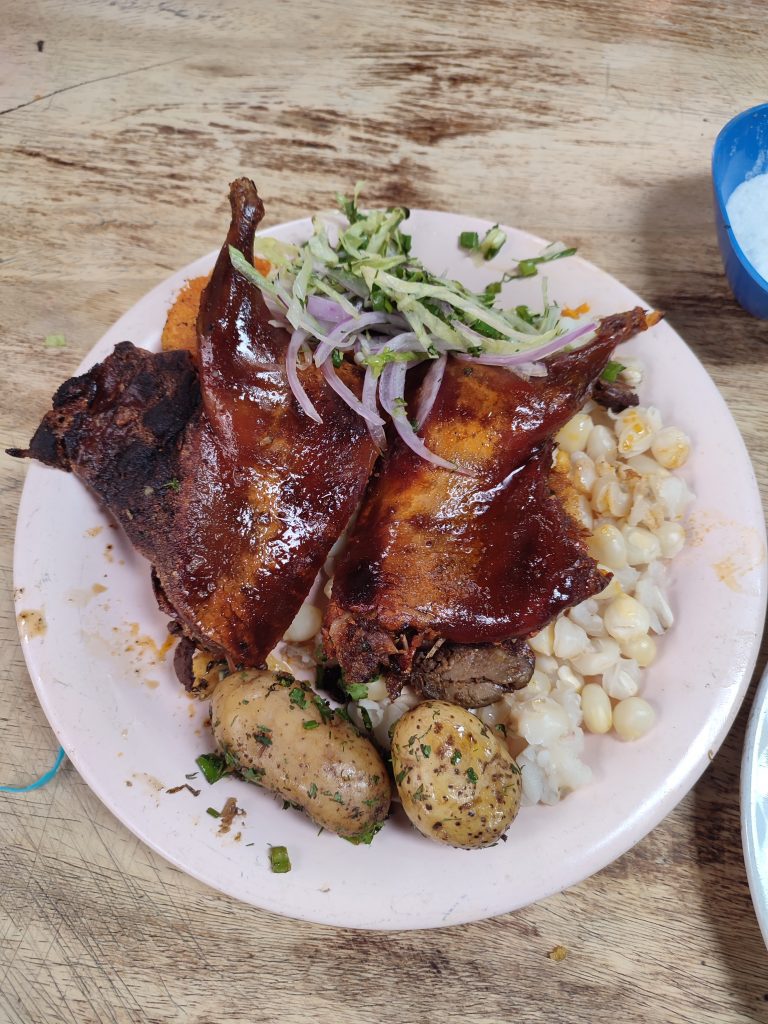 Trying Hornado dish in Cuenca Ecuador